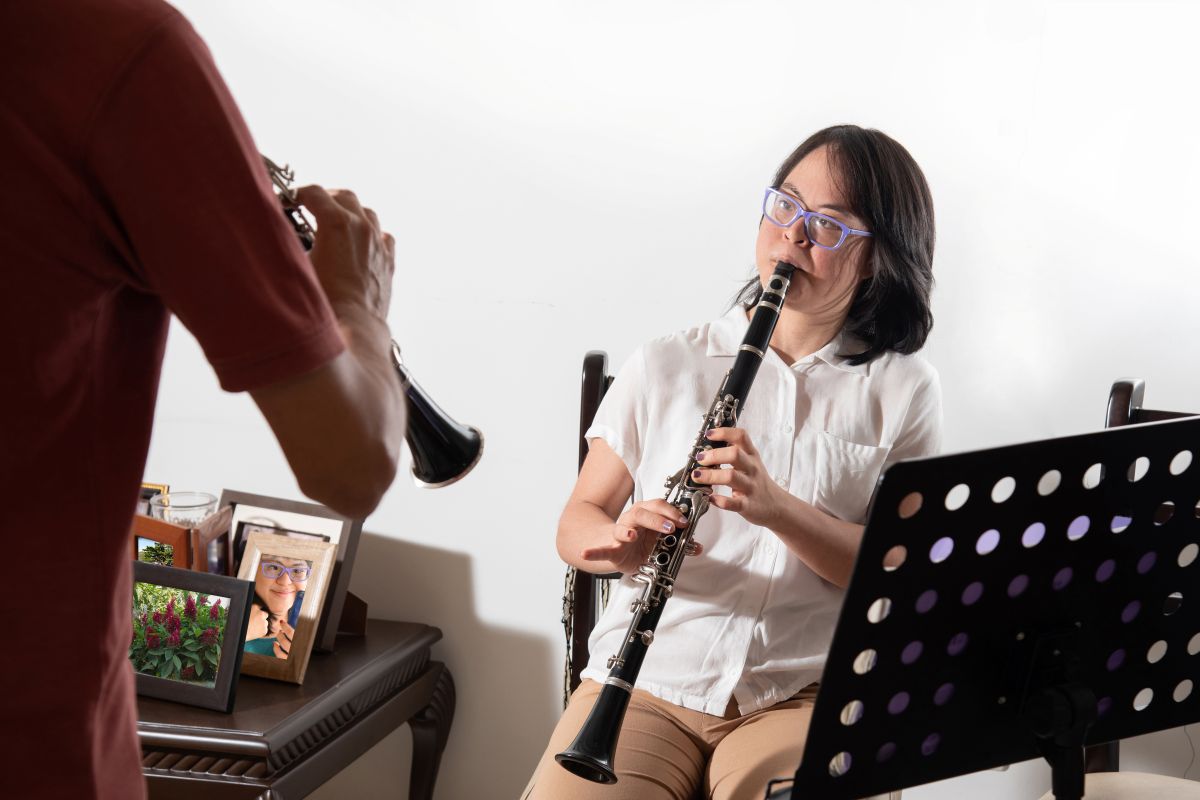 adult woman taking clarinet lessons with a teacher